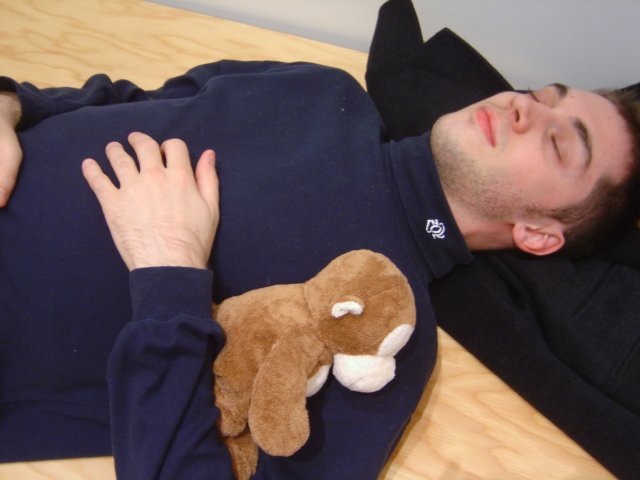 Olivier pretending to sleep and holding my monkey