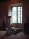 Columns, statues, round rocks and a window