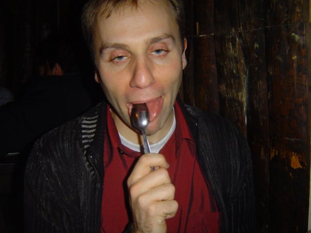 Nico licking a spoon and looking inebriated