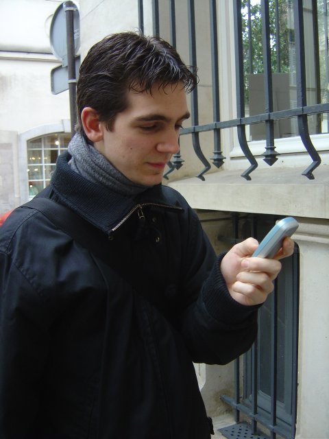 Henri playing with his cell phone