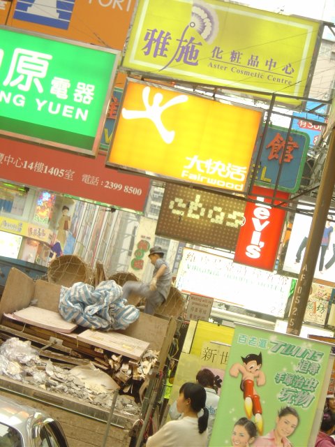 Above head level are colourful signs in the streets