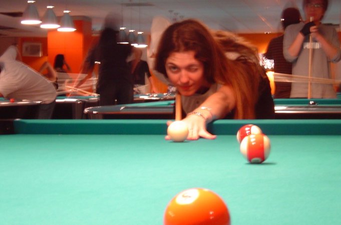 Coralie playing billiards