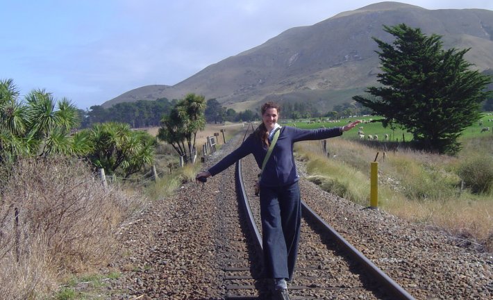 Coralie walking on a train track
