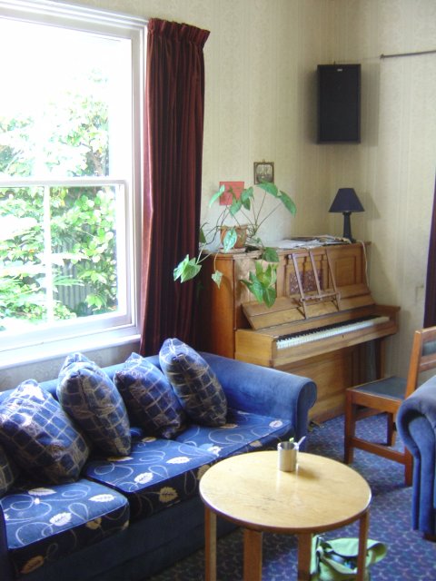 Sitting room with a piano at Christchurch backpackers