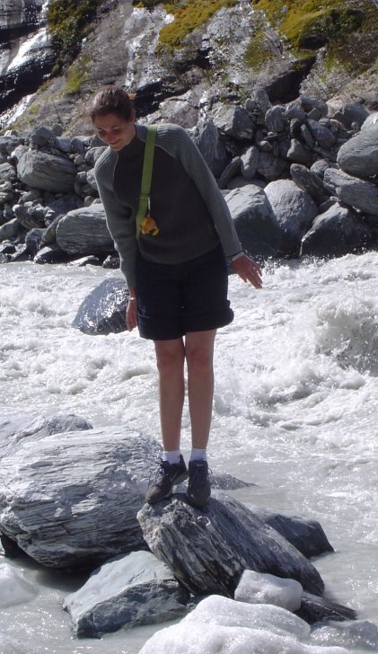 Coralie standing on a rock among the water of a stream (it may not be obvious but I was imitating a penguin. Oh well...)