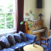 Sitting room with a piano at Christchurch backpackers