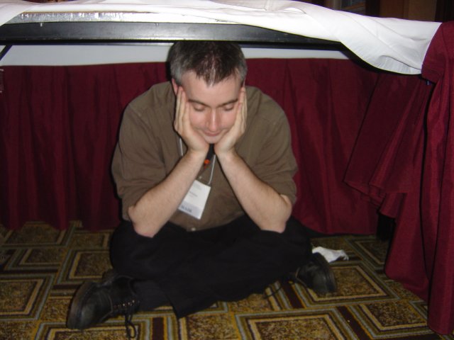 Danbri under the table, pretending to sleep, Hyatt Harborside