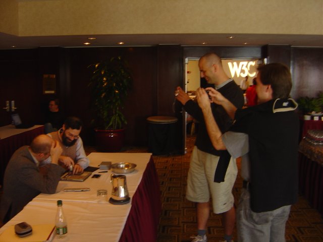 Henry Thomson and Ralph Swick playing with a borken laptop, Dean Jackson and Yves Lafon taking pictures, Hyatt Harborside, Boston