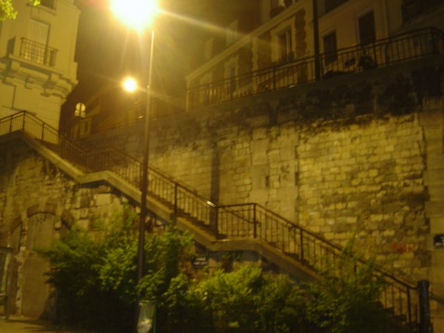 Paris at night: stairs, brick wall, street light