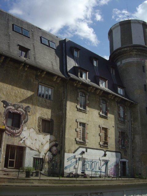 Large dog painted on an old building