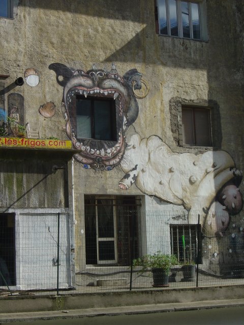 Large dog painted on an old building