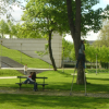 Man on stilts, couple on a bench
