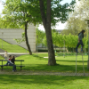 Man on stilts, couple on a bench