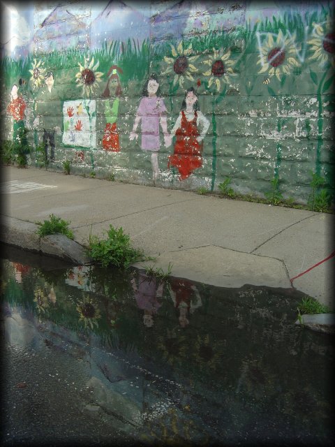 Painted wall reflected in a puddle