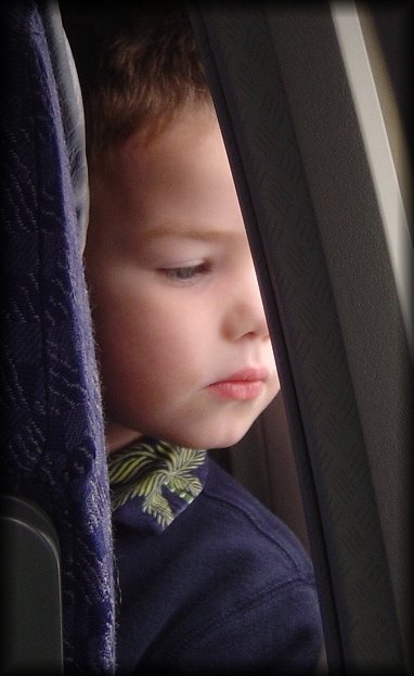 Little boy watching out the window of the San Jose - Chicago plane