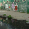 Painted wall reflected in a puddle