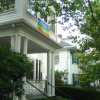 Peace flag above the entrance of a large white house
