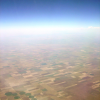View from the plane on fields and haze and sky