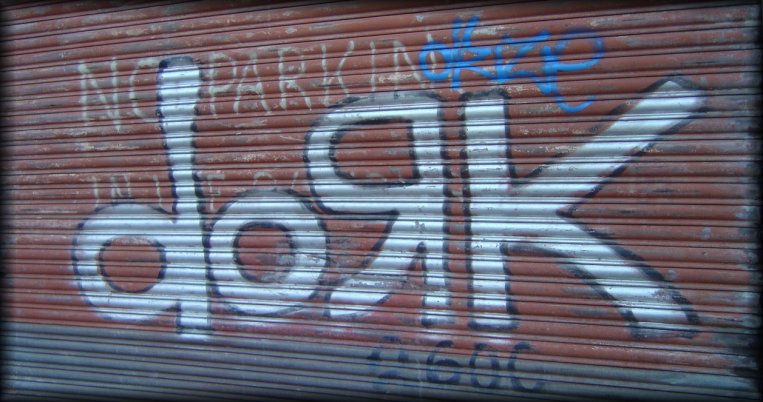 "dork" graffiti on a garage door