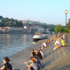Pub patrons chilling out near the water at the sunset