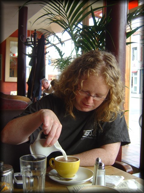 Libby pouring cream in her tea