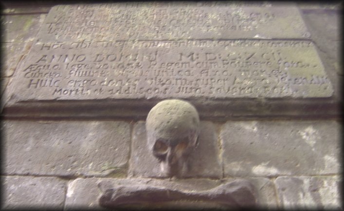 Carved plaque and stone skull