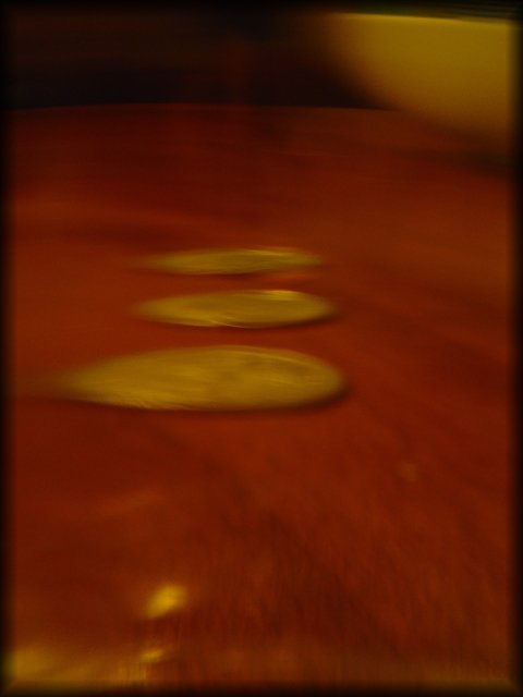 Three coins on the table and a bowl