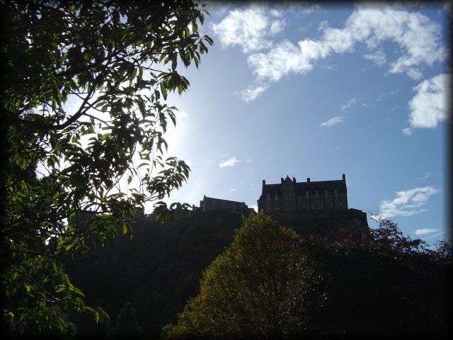 Edinburgh Castle above trees in Princes Street Gardens