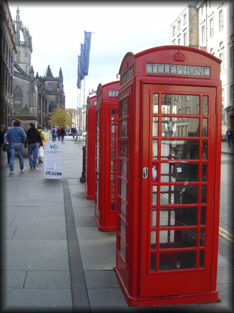 Three red telephone booths on the Royal Mile