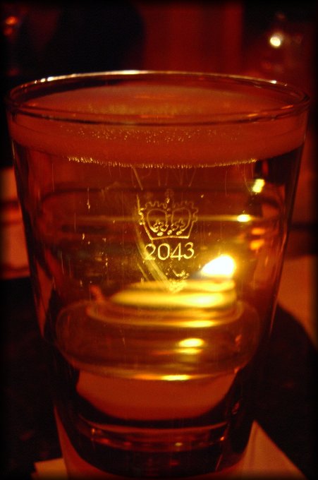 A pint of amber cider, lit by a candle