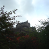 Edinburgh Castle above trees in Princes Street Gardens