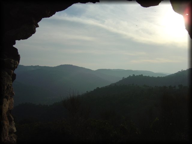 window in the ruins and view on the mountains from Mont Peygros near Auribeau sur Siagne, FR