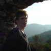 ericP leaning on a stone wall