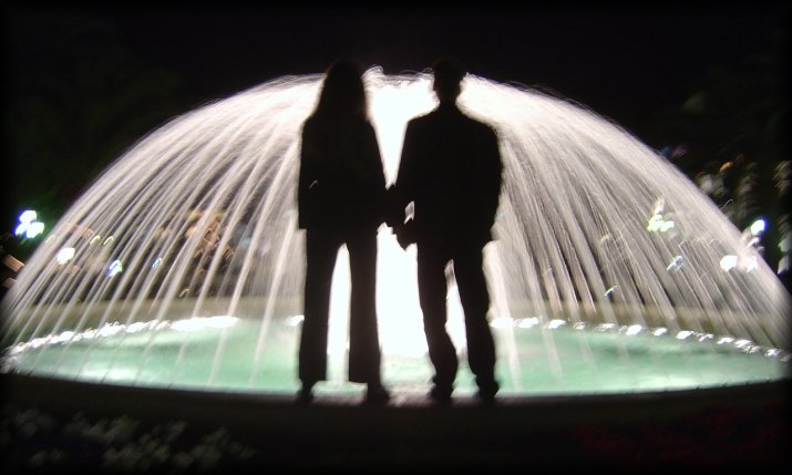 ericP and I standing in front of a brightly lit fountain, Monaco
