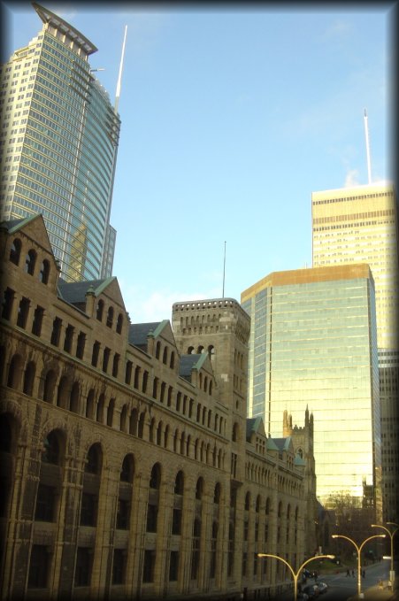 On the left of the Marriott, an old looking building surrounding by skyscrapers
