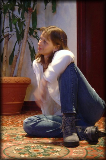 Caroline seated on the floor and leaning on her arm