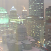 Montreal by night, snow on the roofs and there is a building in the backgroudn which top looks on fire