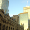 On the left of the Marriott, an old looking building surrounding by skyscrapers