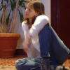 Caroline seated on the floor and leaning on her arm