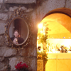 ericP's and my reflection in an oval mirror hung on the brick wall next to a shop