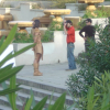 A male model in an interesting outfit posing for a photographer