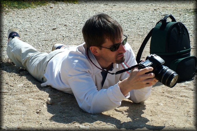 Guillaume, still flat on his belly, checking the photo he just took