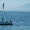 A sailing boat, the sea, and haze in the background hiding a little l'Esterel