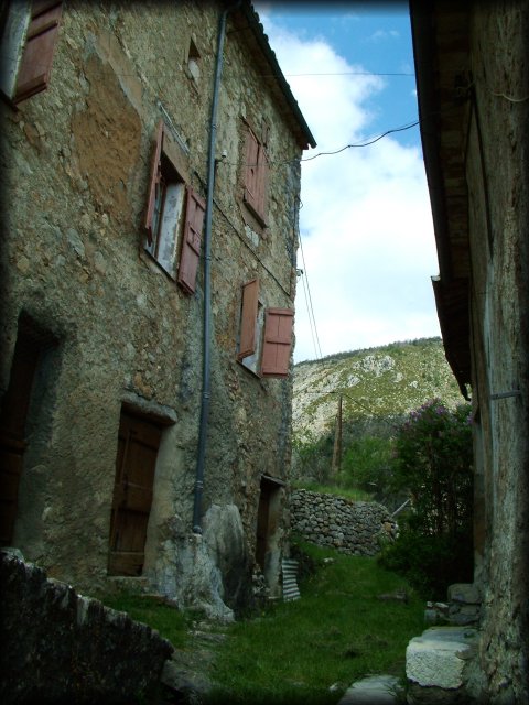 Between two houses, a path of green green grass