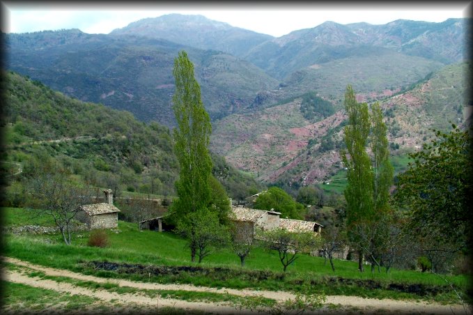 View on Amarines from the dirt road. The mountains opposite are pink/red 