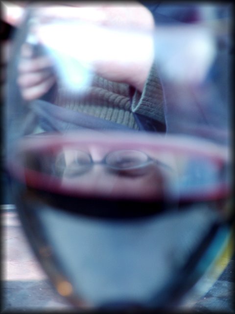 While Amy was fiddling with her camera, I was fiddling with mine, trying to capture a neat reflection of her eyes on the surface of the wine in my glass.