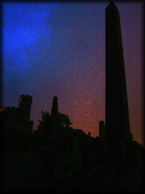 Shadow of obelisk and graves in the Calton Hill cemetery.