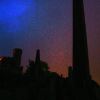 Shadow of obelisk and graves in the Calton Hill cemetery.