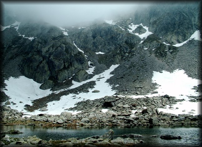 Clouds have gathered low on the mountains around us.