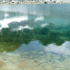 Reflection of the mountain in the blue/green water of the lake.